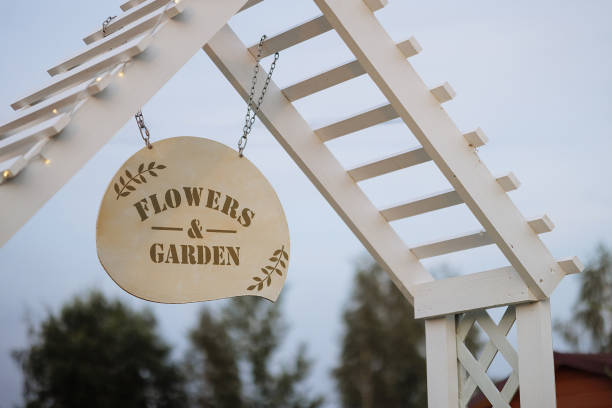 istock Garden sign hanging on a white wooden structure. 1968808888