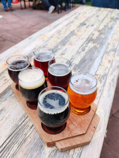 istock Beer samples on beer garden outside restaurant table drink background texture close up photo with copy space. Biergarten, brewery, pub, bar or taproom. 1968816340
