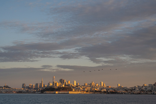 Aerial view across bay to city skyline at sunset, San Francisco