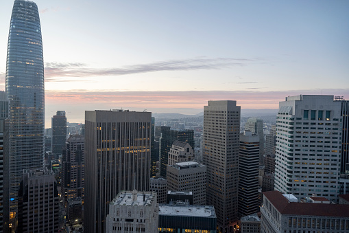 Aerial view of city skyline and Bank of America tower at sunset