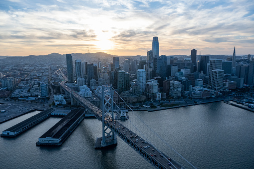 Aerial view of city skyline, calm bay and bridge at sunset, San Francisco