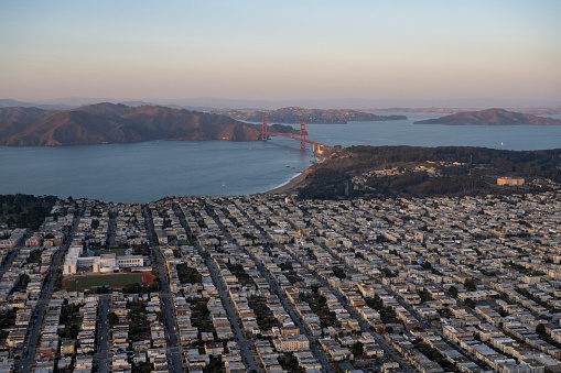 Aerial view of residential district, bay and bridge at twilight