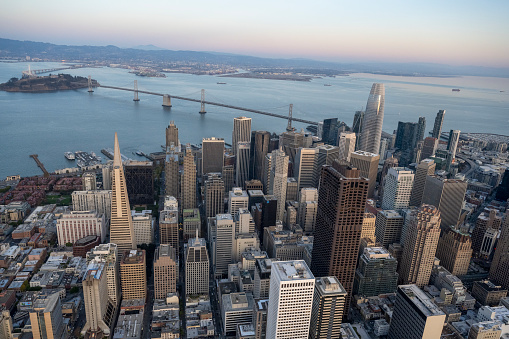 Aerial view of city skyline, calm bay and bridge at sunset, San Francisco