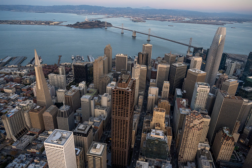 Aerial view of city skyline, calm bay and bridge at sunset, San Francisco