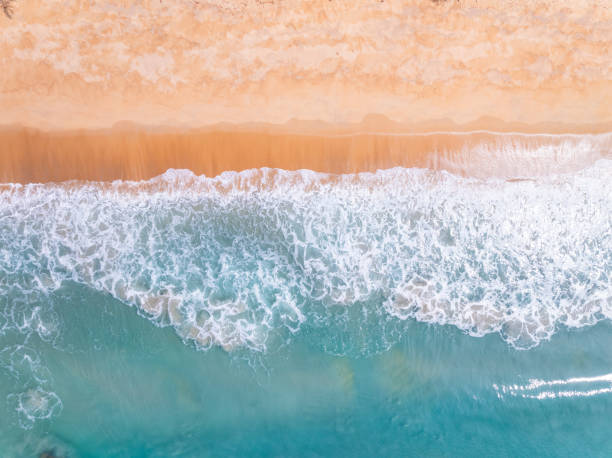 istock Top view beach with waves crashing on sandy shore,Beautiful waves sea surface in summer seascape background,Amazing beach colorful water background 1968934844