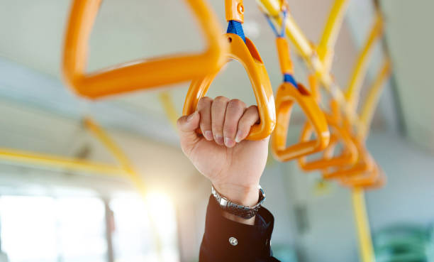 people holding  handle on a train - coach bus bus transportation travel foto e immagini stock