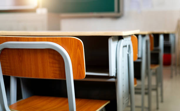 Empty classroom with chairs and desks stock photo