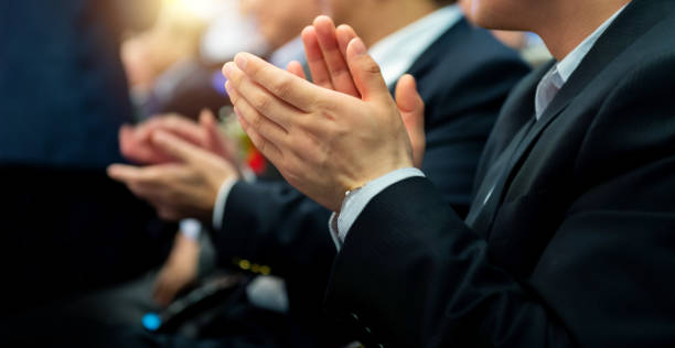 istock Group of business people clapping in a row 1968966603