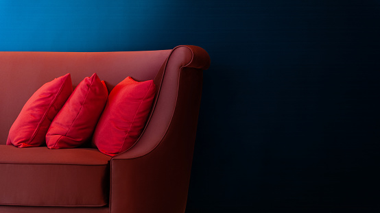 Three red pillows on a contemporary sofa