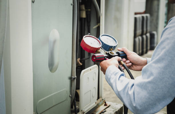 istock Air conditioner technician is using a manifold gauge to check the refrigerant in the system to inspect and repair the outdoor air compressor. 1969005317