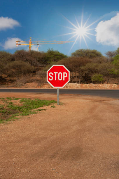 istock stop sign dirt road and a crane in the background 1969009505