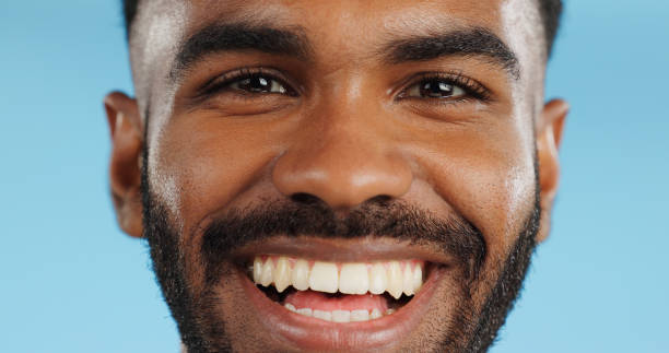 happy, smile and face of black man in studio, blue background and mockup space with happiness or advertising. portrait, closeup and marketing for skincare, wellness or healthy dermatology care - lifestyles toothy smile care beauty foto e immagini stock