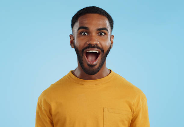 istock Wow and excited black man in studio isolated on a blue background mockup space. Portrait, surprise and happy person in shock for good news, information and winner of bonus promotion 1969010026