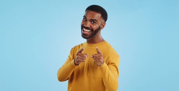 istock Face, excited and black man pointing at you for decision, choice or selection in studio isolated on a blue background mockup space. Portrait, hand gesture and person hiring, recruitment or invitation 1969010562