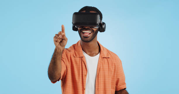 istock Man, virtual reality and glasses in studio with hand, click and swipe with smile for metaverse by blue background. Person, AR vision and futuristic game with 3D user experience, cyber ui and esports 1969011126