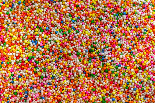 confectionery ingredients rainbow sprinkles, texture sprinkle of multicolor rainbow candy for various toppings