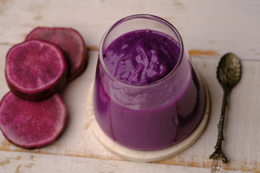 Bubur ubi ungu. smoothie purple sweet potato. made from purple sweet potato and young coconut. healthy food for the diet. contains complex carbohydrates and healthy fats. vegan and vegetarian friendly