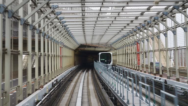 Passing Tokyo Rainbow Bridge tunnel, Yurikamome monorail train on way to Odaiba island in Tokyo Bay.