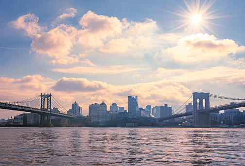 Panoramic view of Brooklyn Bridge and Manhattan Bridge with skyline.