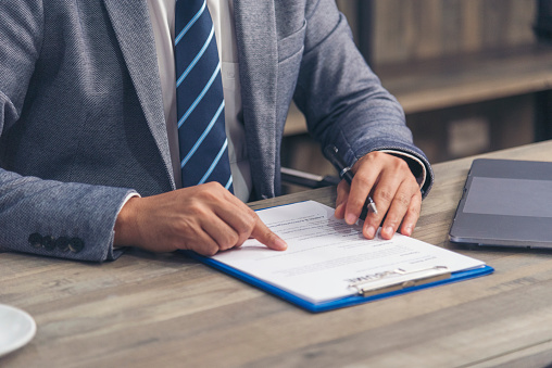 Close up manager businessman hands sign contract working meeting. Asian business man using pen signing on new contract to starting projects in conference room.  Business agreement concepts.