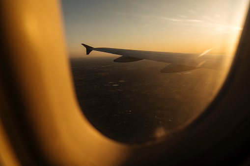 While the plane is in the air, the sun's rays may be seen on the horizon