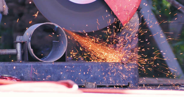 istock Hot flame welding metal work cutting fire iron workshop. Welding machine iron metal sparking. Locksmith using Welding machine cutting metal processing grinder. Close up hands Sparks in metalworking 1969070370