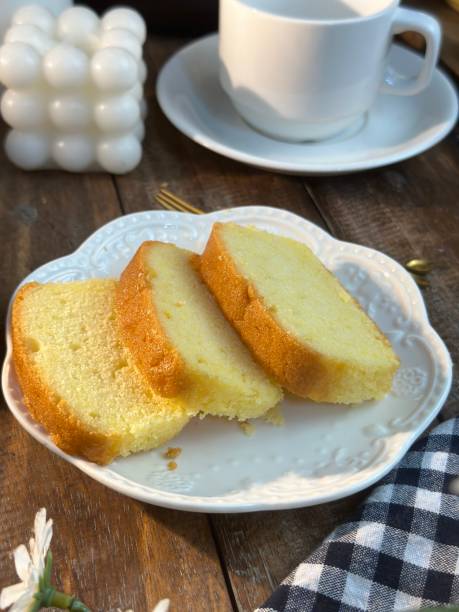 istock Slices of butter cakes with small white tea set. 1969080277