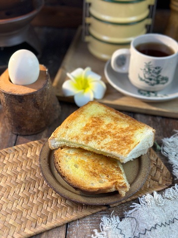 Common oriental breakfast set in Malaysia consisting of coffee, nasi lemak, toast bread and half-boiled egg