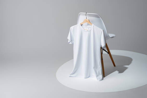 istock White blank t-shirt hanging on chair in empty room 1969161370