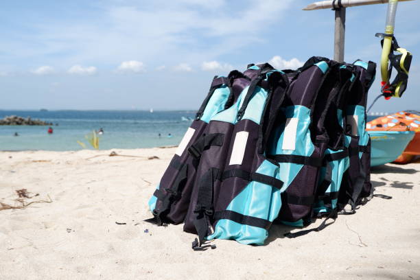 giubbotto di salvataggio blu o boa di sicurezza sulla sabbia della spiaggia. - life jacket life belt buoy float foto e immagini stock