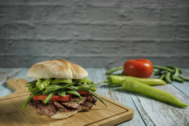 Homemade tri-tip sandwich with roasted beef,red pepper,spinach and barbecue sauce
