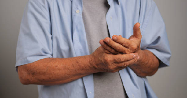 istock An Asian man has tingling and numbness in his hand which causes beriberi. 1969207424