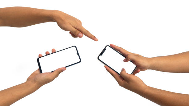 istock hands using smartphone with blank screen, isolated on white background, Close up of hand holding modern smart phone mockup. New modern black frameless smartphone mockup with blank white screen. 1969214877