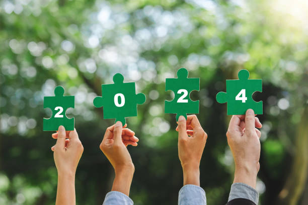 istock 2024 World environment day and ESG Concept of teamwork and partnership Hands join Jigsaw puzzle pieces with number 2024 global community sustainable Save Earth. 1969219009