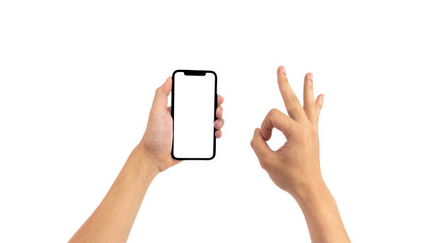 istock hands using smartphone with blank screen, isolated on white background, Close up of hand holding modern smart phone mockup. New modern black frameless smartphone mockup with blank white screen. 1969226529