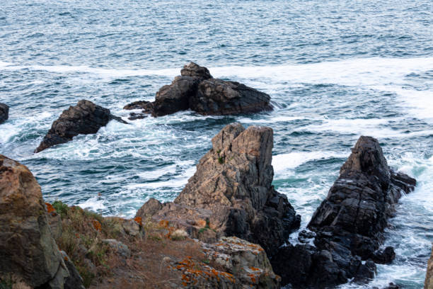 istock Rocks and waves on sea shore 1969282117