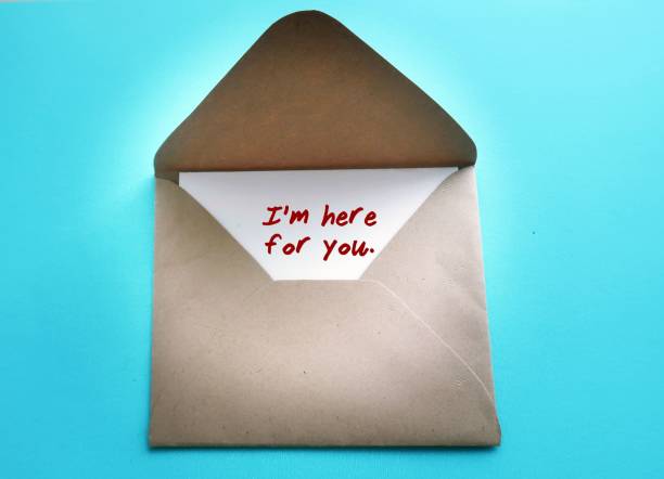Envelope with text written card I'M HERE FOR YOU - concept of Emotional Support - a cheer up note to someone to encourage them in a bad day