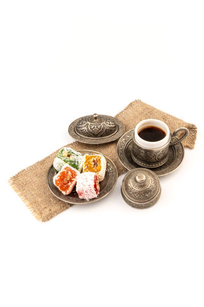 istock Turkish Coffee with Turkish Delight on authentic metal plate, isolated on white background 1969316435