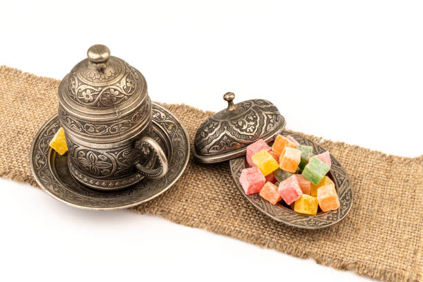 istock Turkish Coffee with Turkish Delight on authentic metal plate, isolated on white background 1969316962