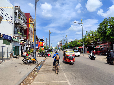 In the heart of Bangkok, a classic green and yellow taxi with its friendly driver patiently awaits passengers amidst the busy city streets. With its iconic green and yellow colors and traditional design, this taxi offers a glimpse of the city's rich culture and history while providing convenient transportation for locals and tourists alike.