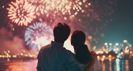 Happy loving couple watching fireworks.