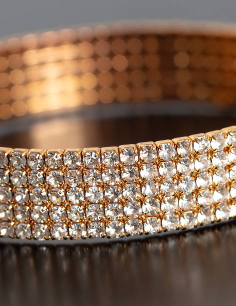 istock Gold bracelet with precious stones isolated on a black background 1969339450
