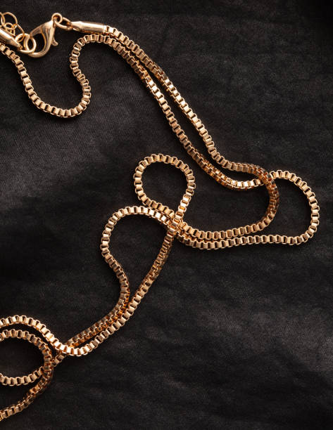 istock Gold chain on black silk fabric. Close-up 1969341249