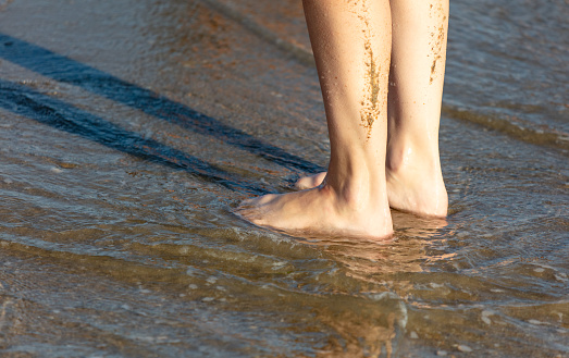 Bare feet on the seashore.