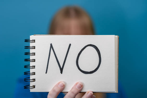 istock Assertive woman holds a card with the words no, no acceptance 1969357481