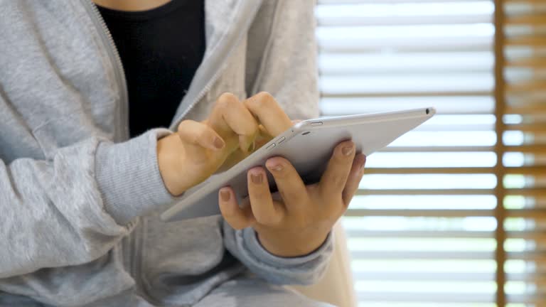 Woman hands using smartphone digital technology tablet empty blank screen. Close up Hands women holding smart tablet touch screen shopping online, call. Woman using mock up mobile at home office