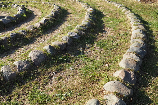 Stone labyrinth near the Devil's Stul rock on Lake Onega. Zaozerye, Petrozavodsk, Karelia, Russia. A magical place for the rituals of the ancient Karelians and Finns. Ethnographic northern tourism
