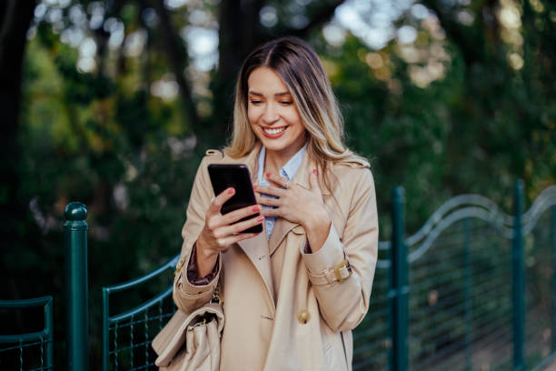 istock Woman having a video call on smartphone while in city downtown. 1969411143