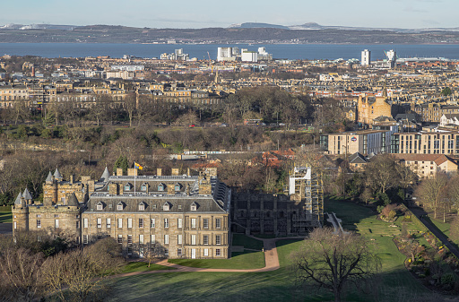 Edinburgh, Scotland - Jan 17, 2024 - Aerial view of Palace of Holyroodhouse and Holyrood Park seen from the top of Salisbury Crags. Amazing Edinburgh Cityscape, Destinations in Europe, Copy space, Selective focus.