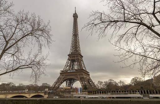 France, Paris - Jan 4, 2024 - Nice scenery of Eiffel Tower and Seine River in Paris at Afternoon. Destinations in Europe. Space for text, Selective focus.